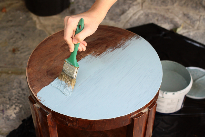 Person painting a table