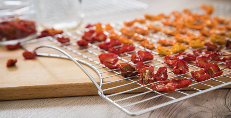 Dehydrate,Dried,Yellow,And,Red,Tomatoes,On,Stainless,Steel,Dehydrator Food ready to be put in the dehydrator